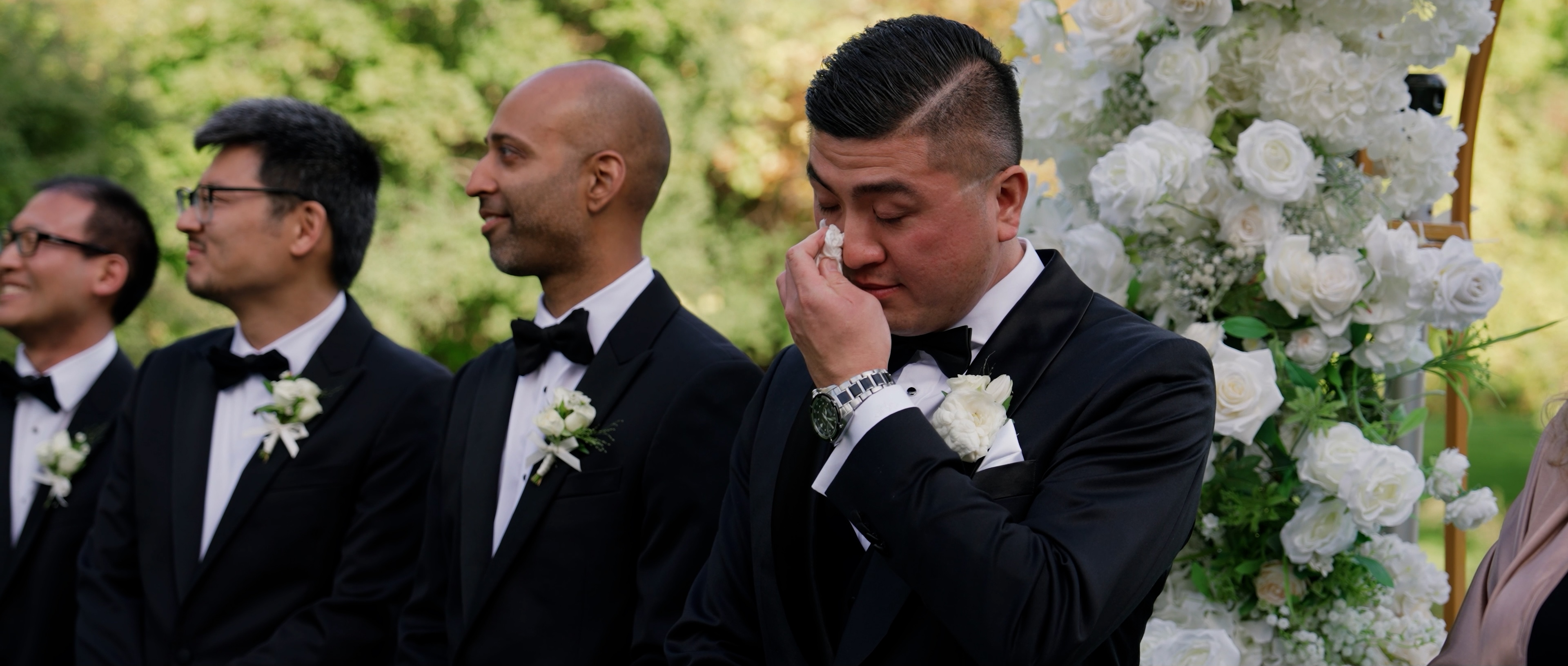 Groom wiping tears during ceremony