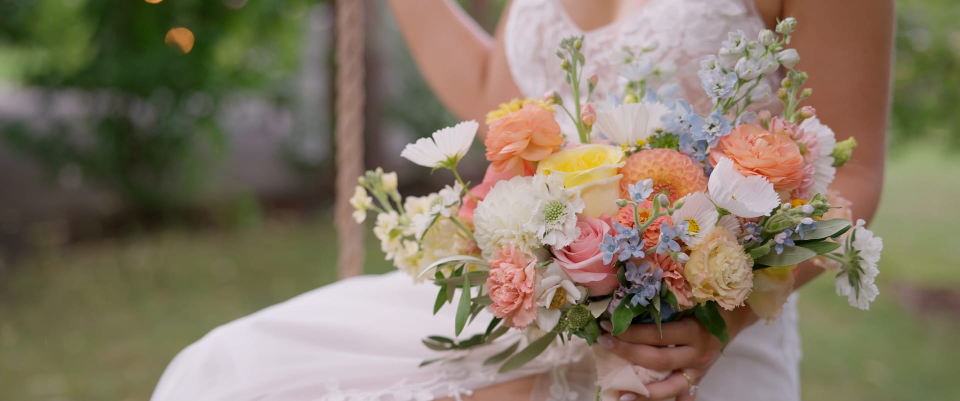 Close-up of a bride's bouquet of roses and wildflowers — documentary wedding film